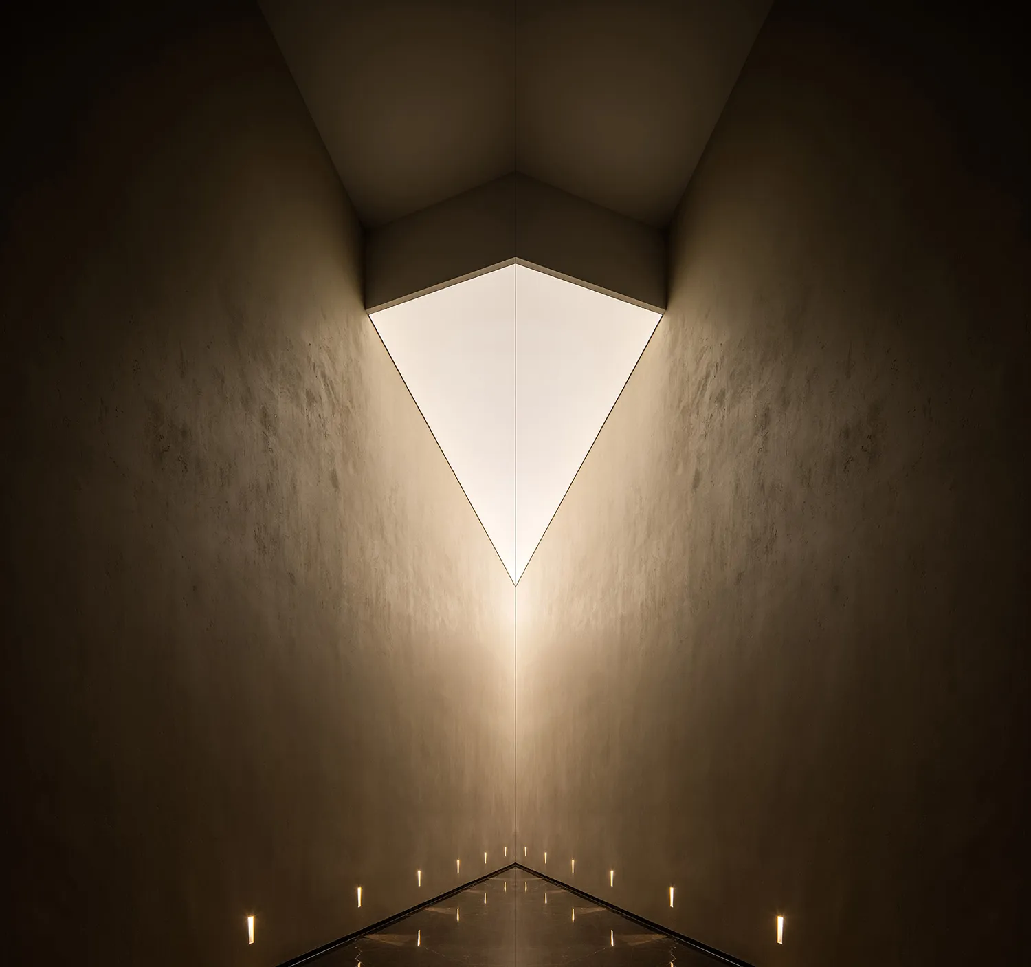 A modern interior design featuring contemporary lighting and concrete walls.