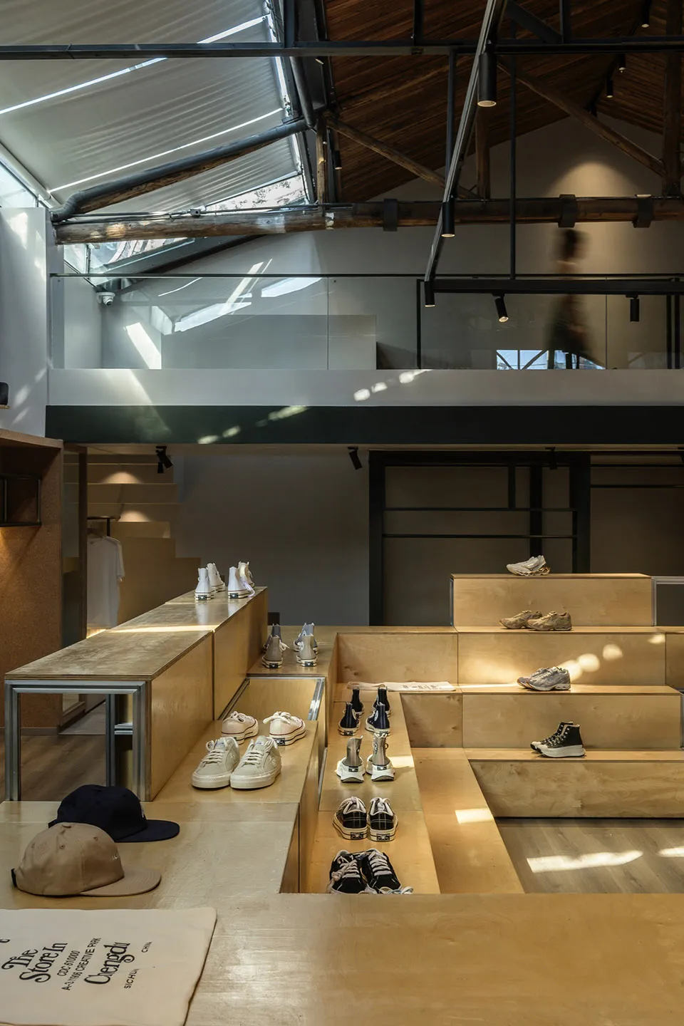A modern retail shop featuring wooden display shelves and a glass wall.