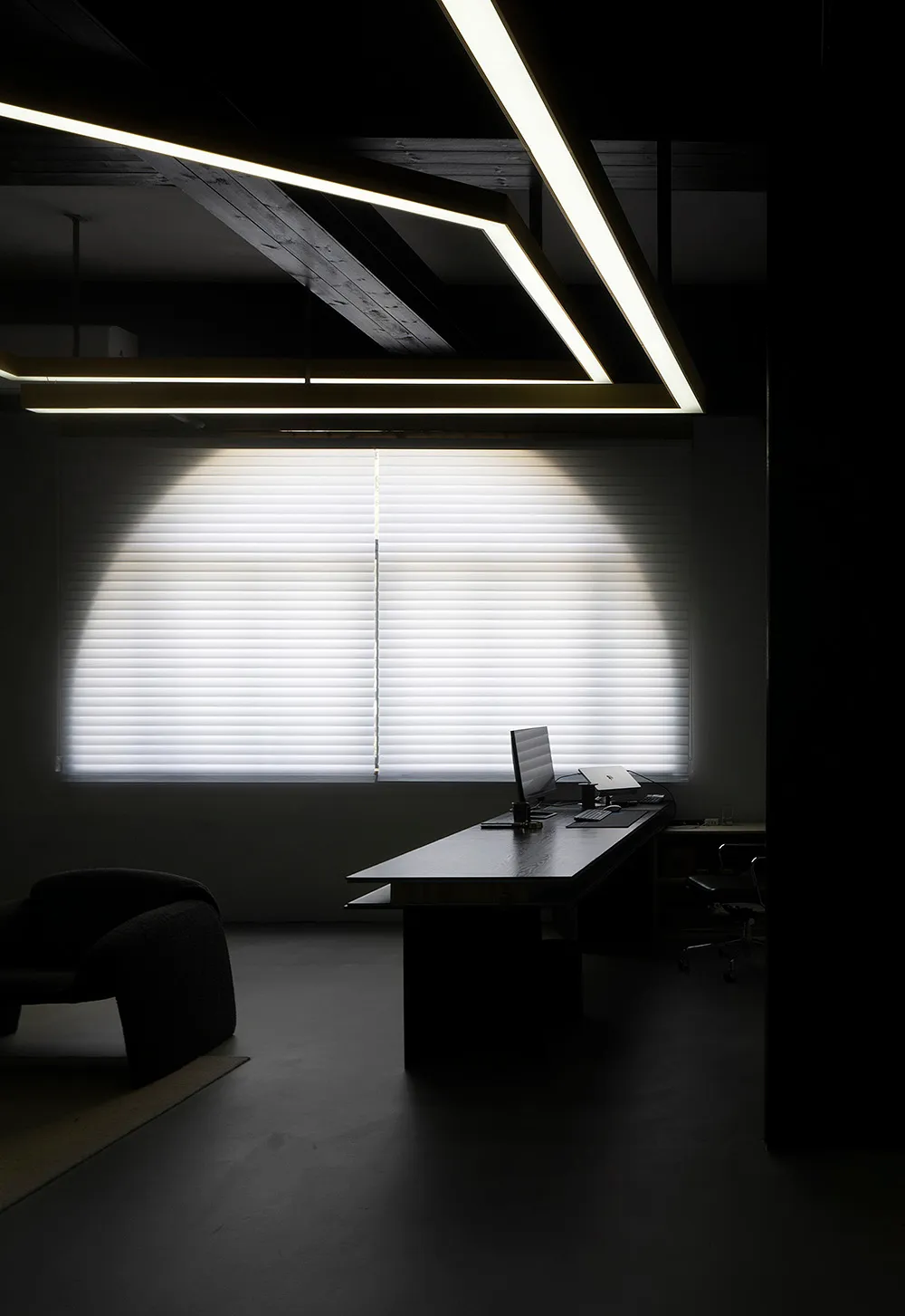 A modern office space featuring glass and concrete elements.