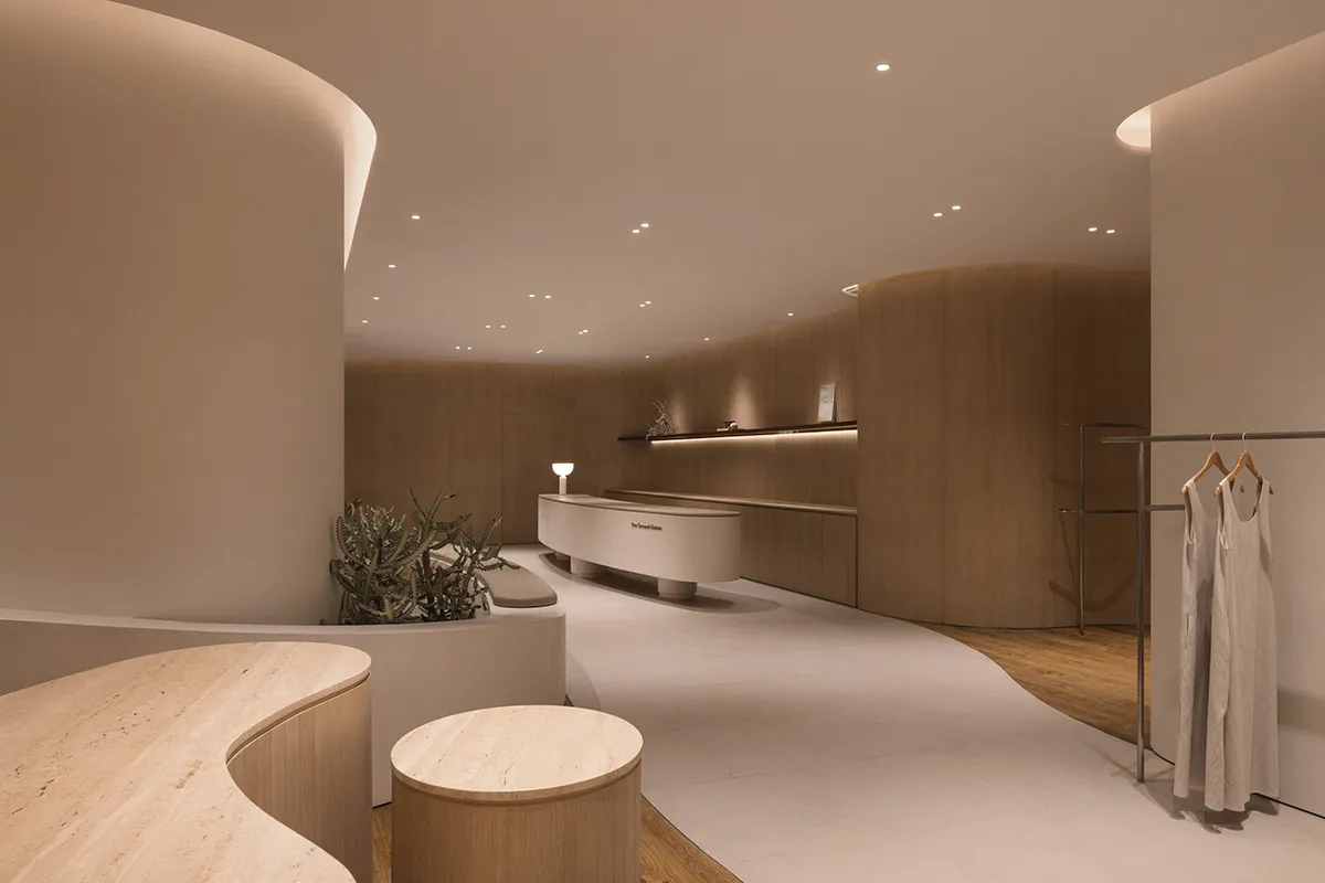 A modern retail storefront with wooden interiors and curved architecture.