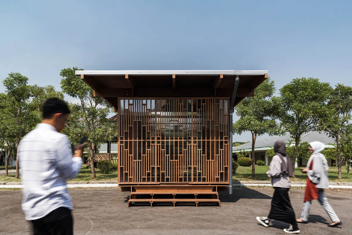A minimalist modern office space with wooden and glass elements.
