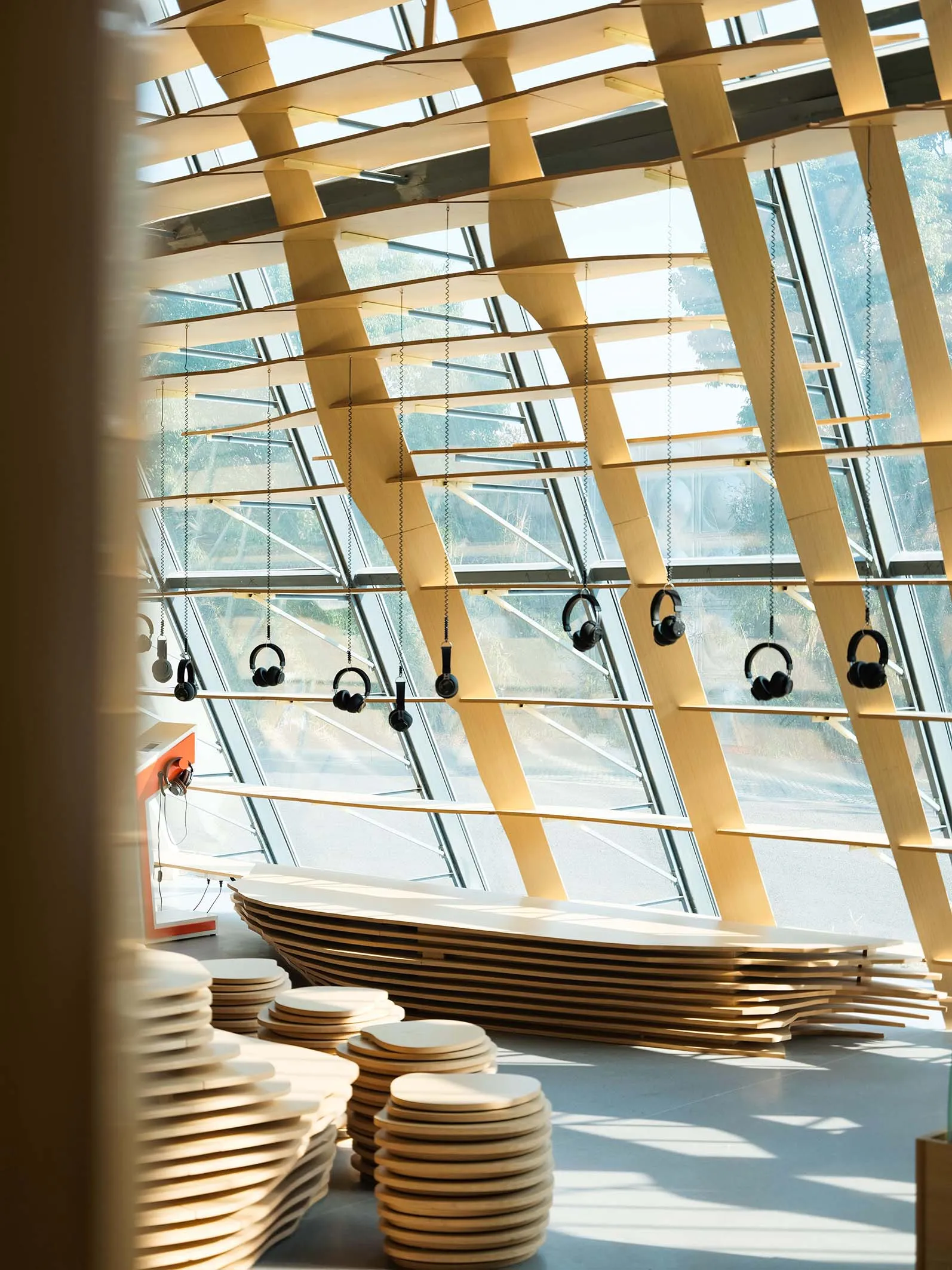 A modern space featuring a wooden lattice structure suspended from the ceiling.