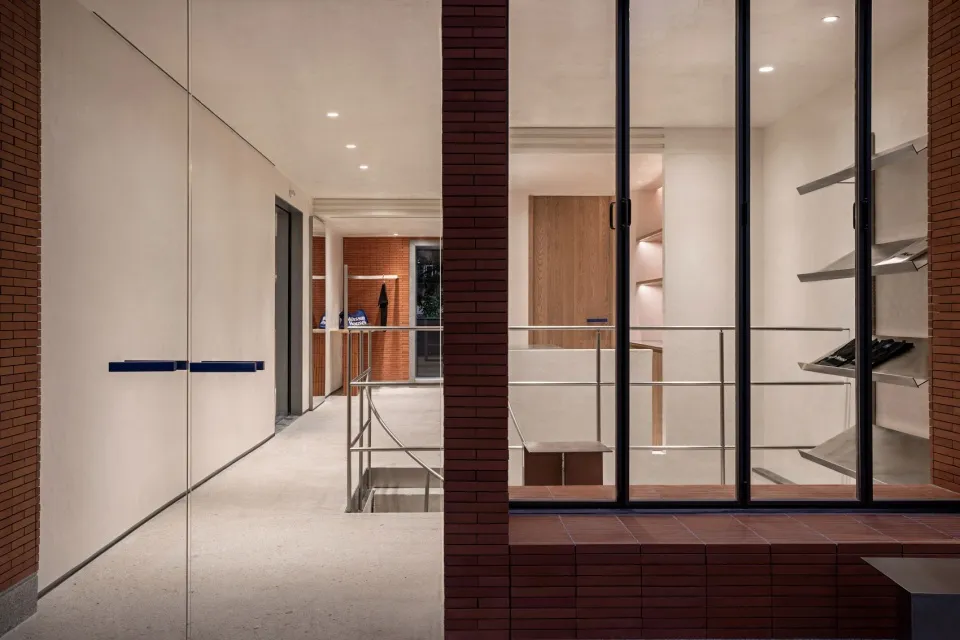 A modern office space featuring brick, concrete, glass, and metal materials.