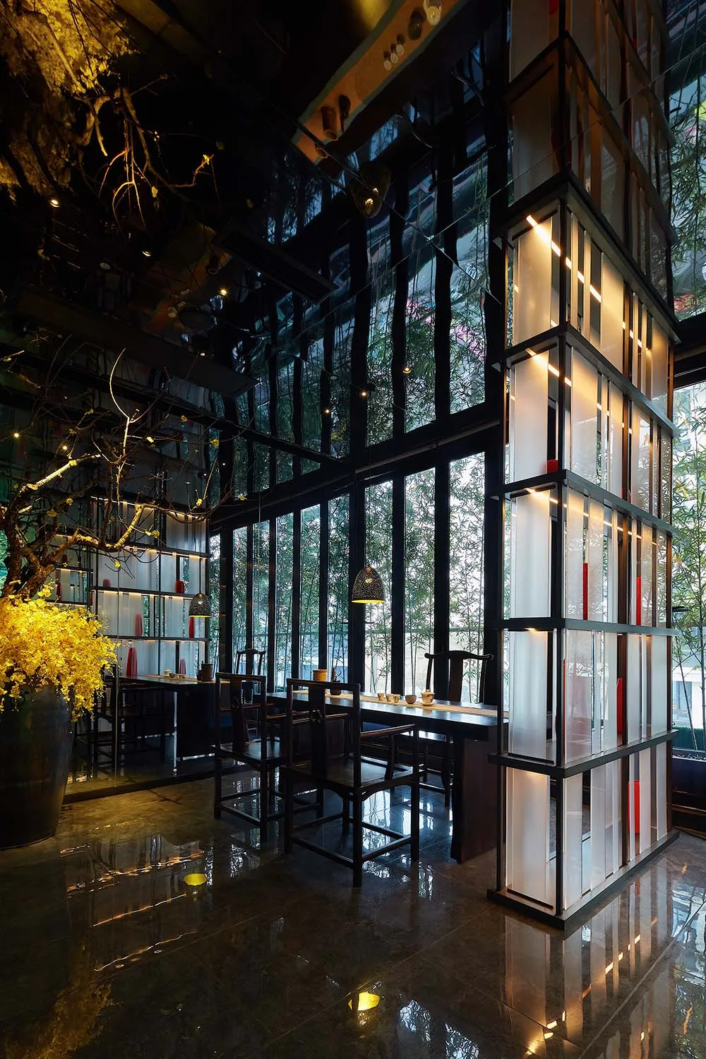 A modern restaurant interior with large glass windows and wooden furniture.