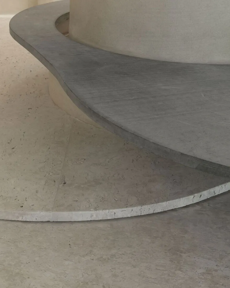 Close-up view of a minimalist interior space featuring concrete materials.