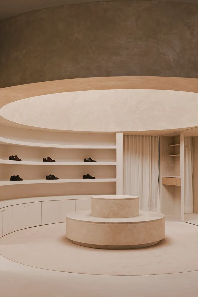A minimalist shoe closet featuring concrete and wood materials.