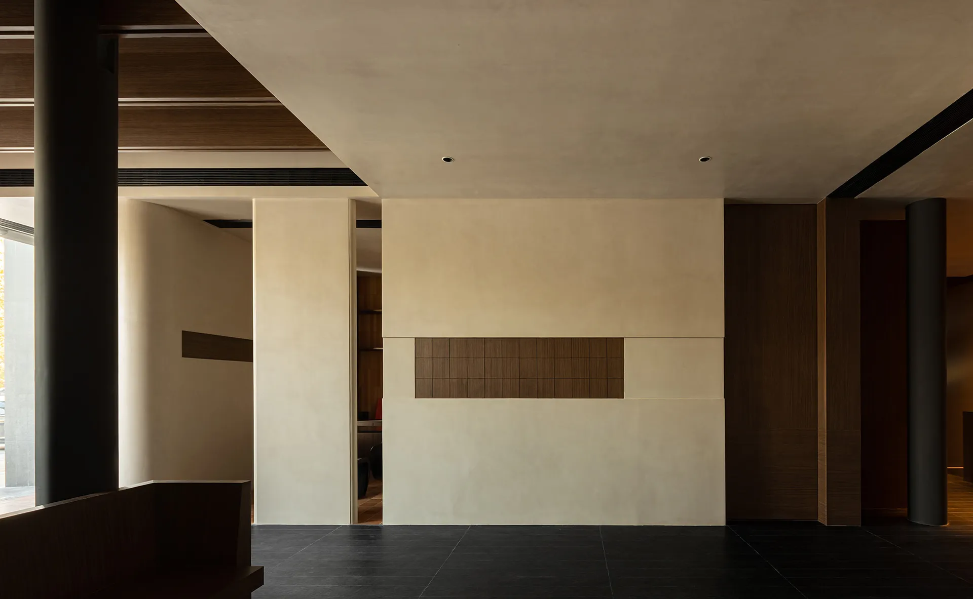 A modern living room featuring concrete walls and flooring