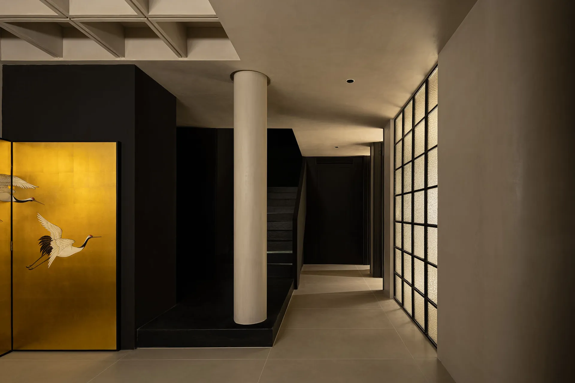 A modern interior designed with black and white elements, featuring concrete floors, white glass walls, and black fixtures.