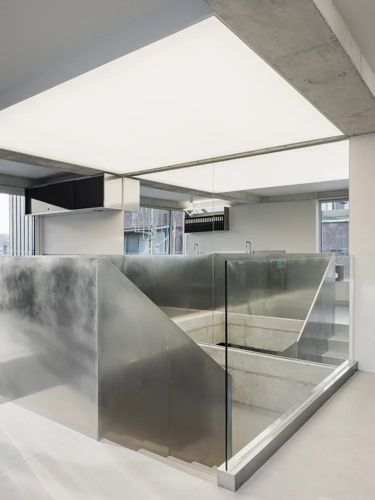 An interior office space featuring modern, minimalist design with concrete elements.