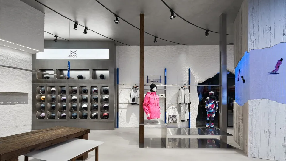 A modern retail storefront featuring industrial design elements with metal shelving and concrete surfaces.