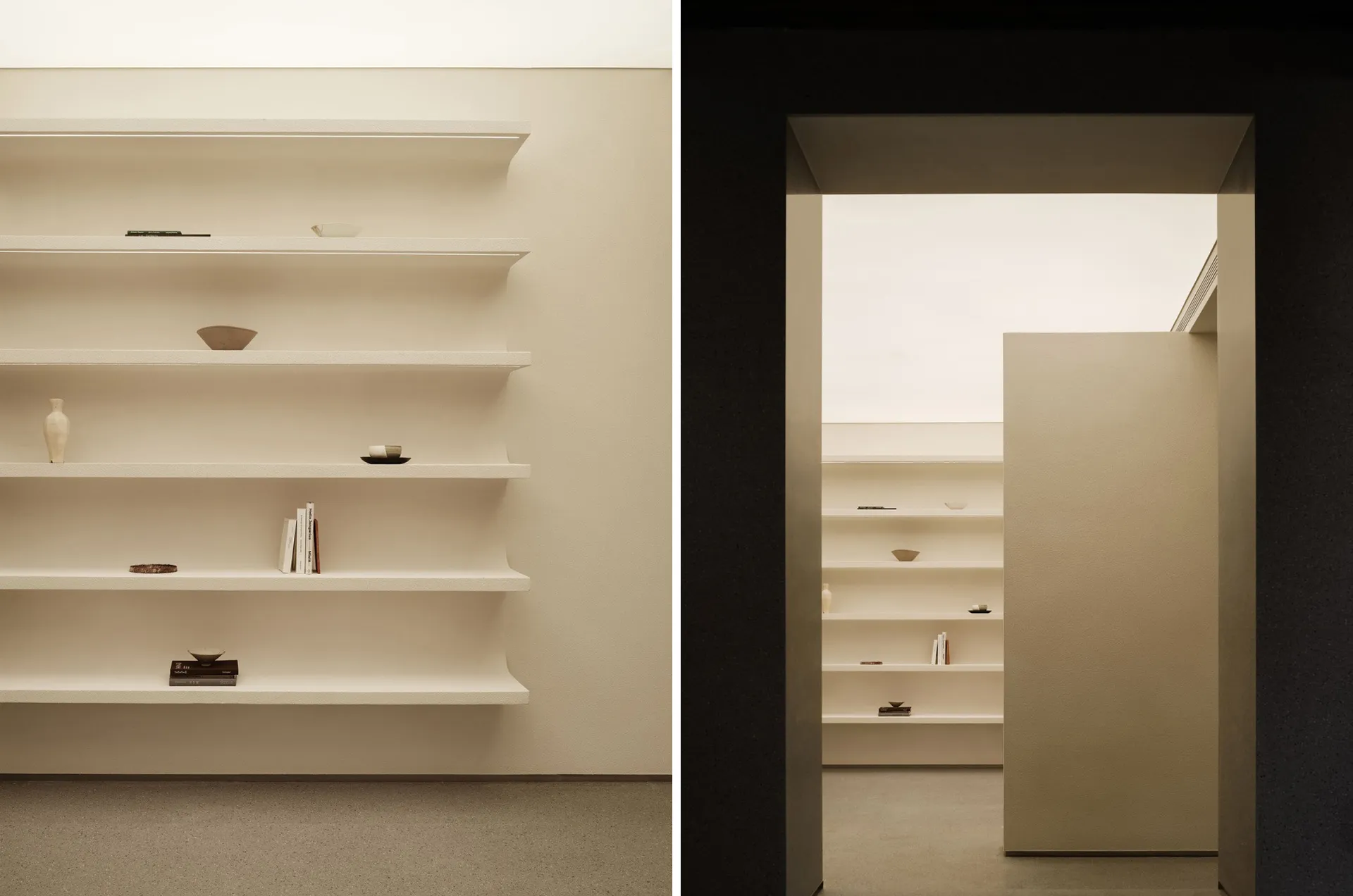 A minimalist interior space featuring concrete white shelves.