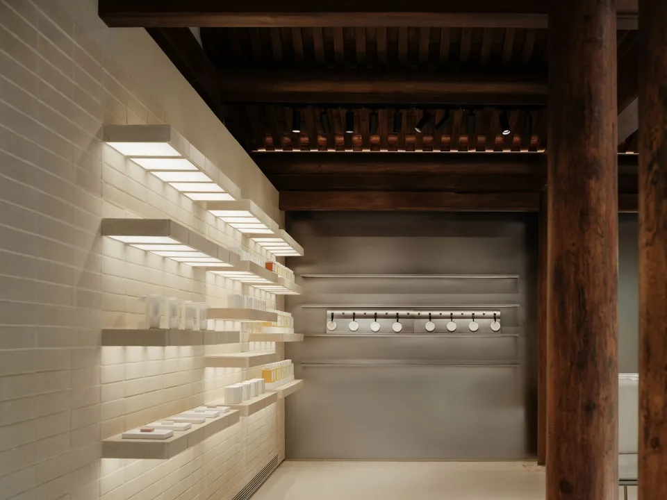 A minimalist interior space featuring light concrete walls and modern design elements.
