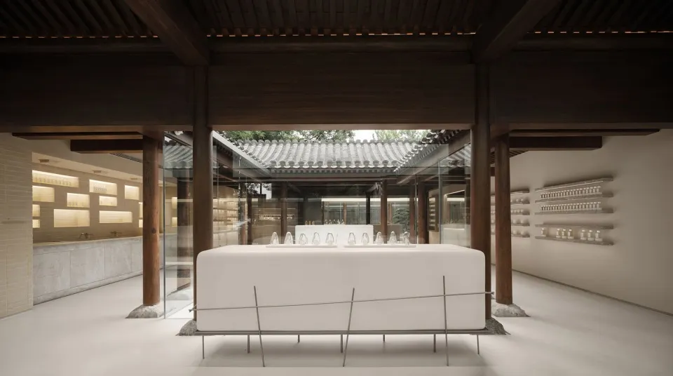 A minimalist modern coffee shop with a white table and glass bottles on shelves.