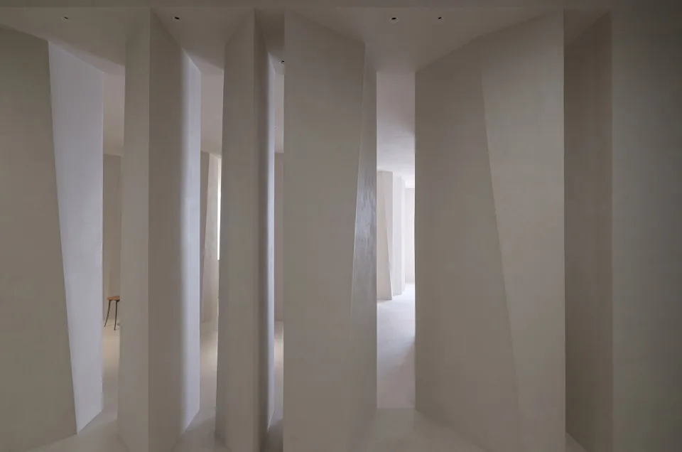 A minimalist interior featuring modern, tall, concrete columns.