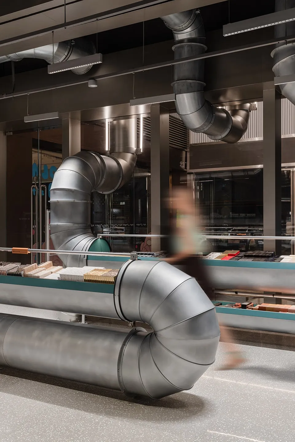 Industrial-style retail space featuring metallic ductwork and concrete flooring.