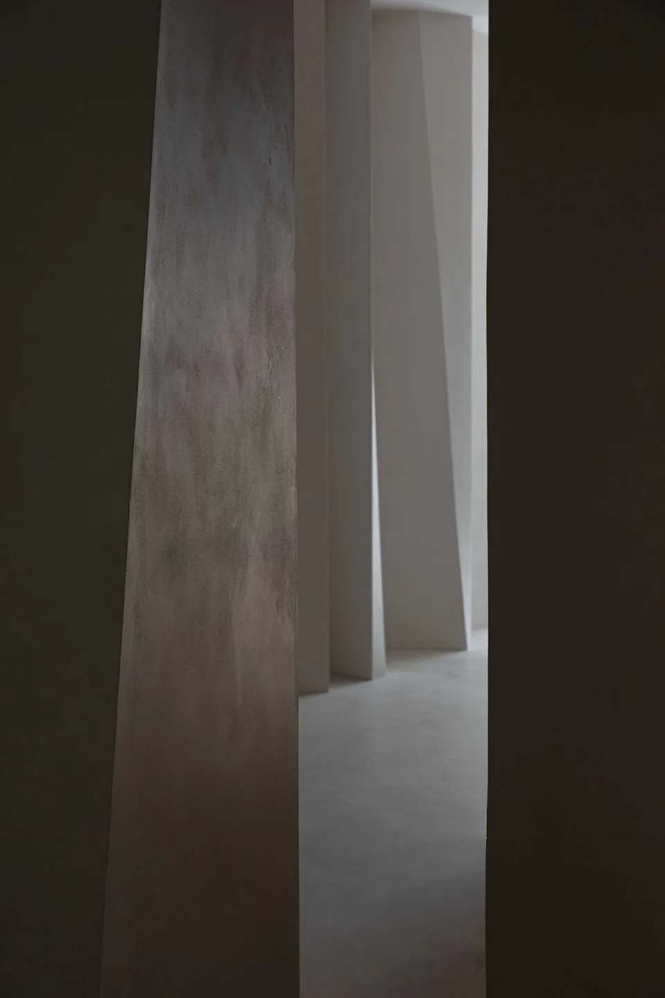 Minimalist modern interior design featuring concrete stones as a primary material.