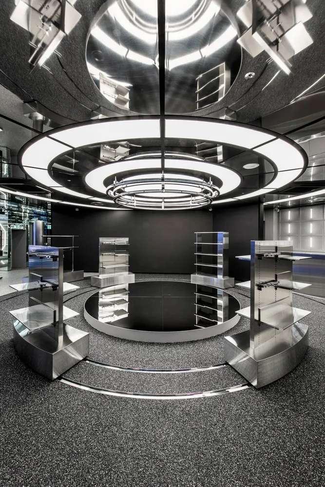 Modern showroom featuring steel structures and circular lighting design.