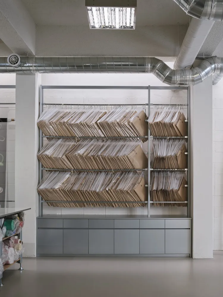 Large industrial storage rack filled with cardboard boxes in a warehouse setting.