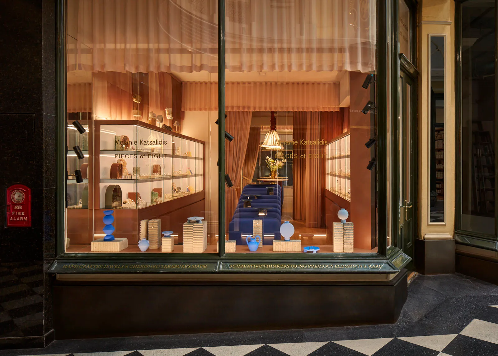 A glass display case inside a modern retail storefront showcasing jewelry and decorative items.