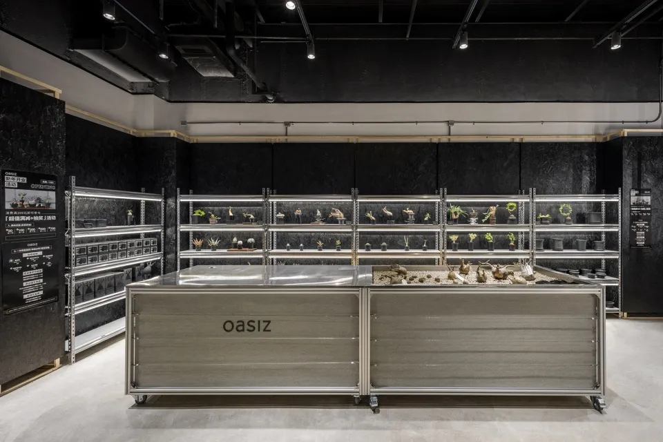 An interior design of a modern plant shop with a focus on metallic and glass elements.