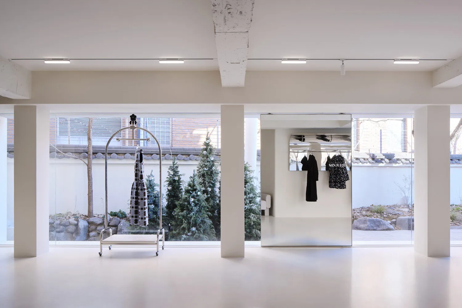 A modern retail space featuring clear glass elements and a minimalist design.