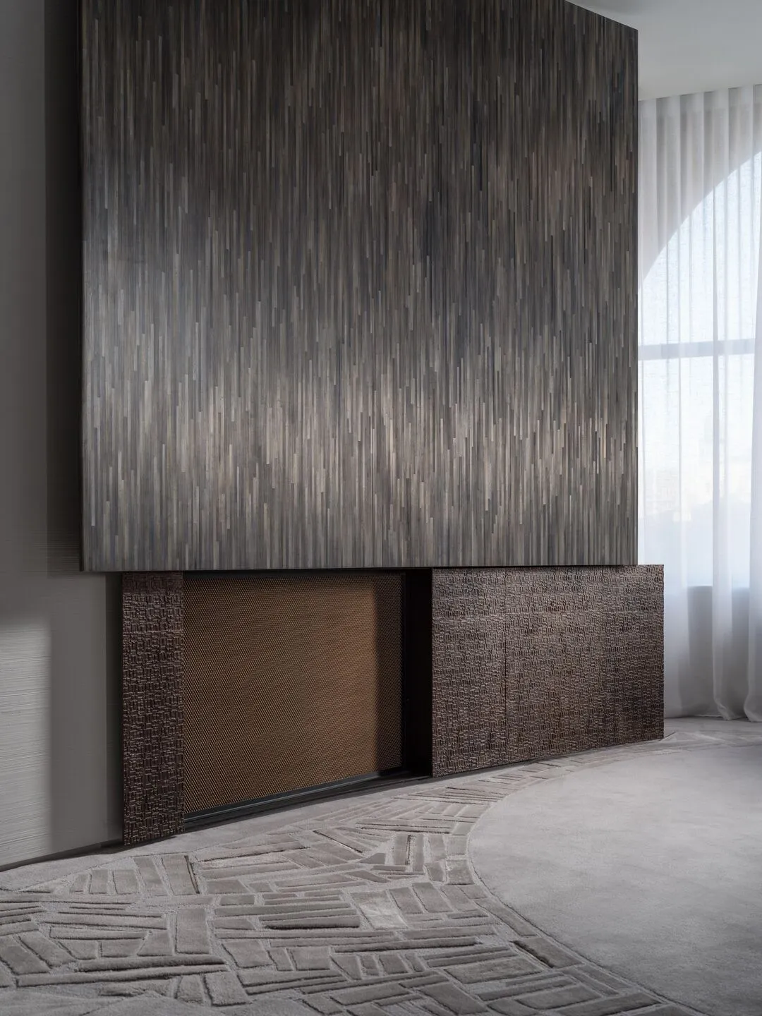 A modern residential interior featuring wood elements and a geometric carpet pattern.