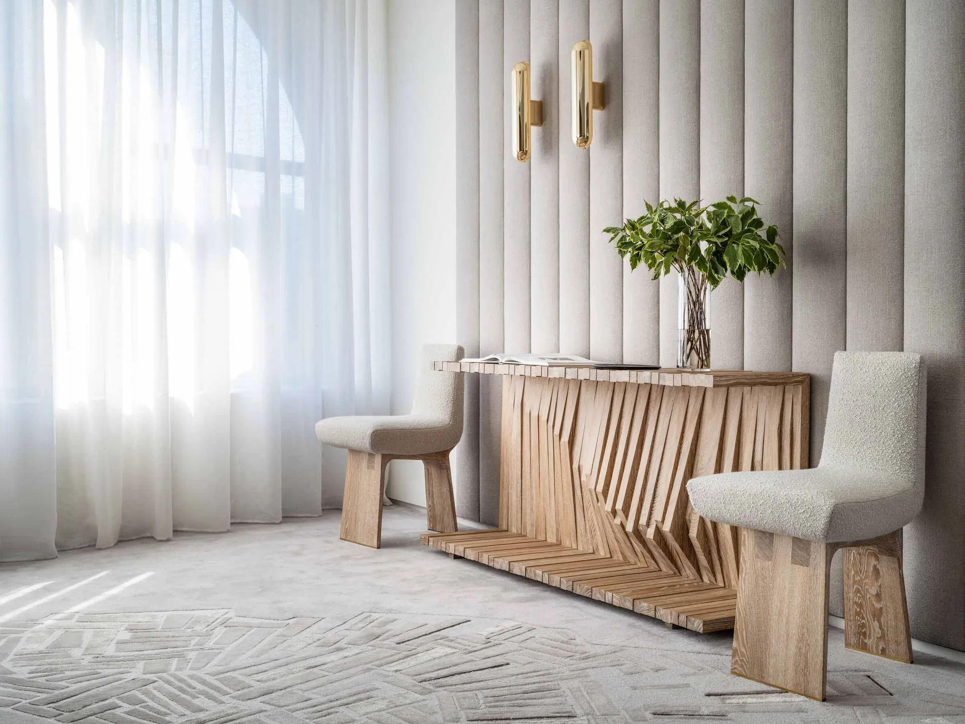 A minimalist interior design featuring a wooden console table, white upholstered chairs, and a white textured rug.
