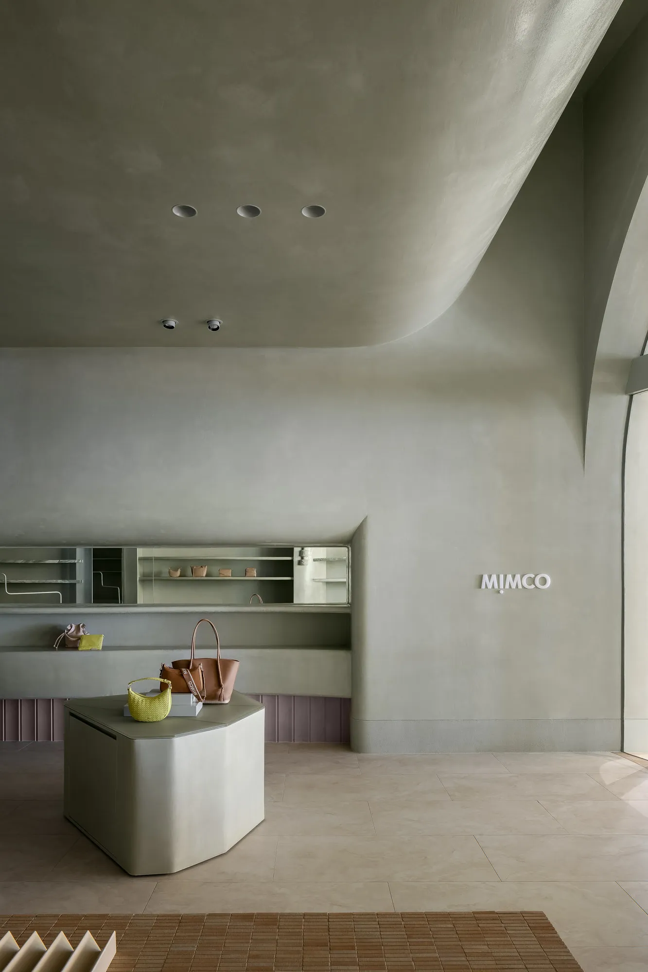 A modern retail space featuring concrete shelves and minimalist design