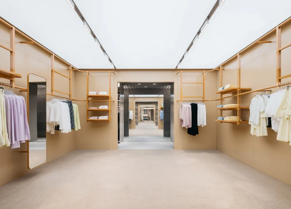 A clothing retail store featuring a minimalist design with wood accents.