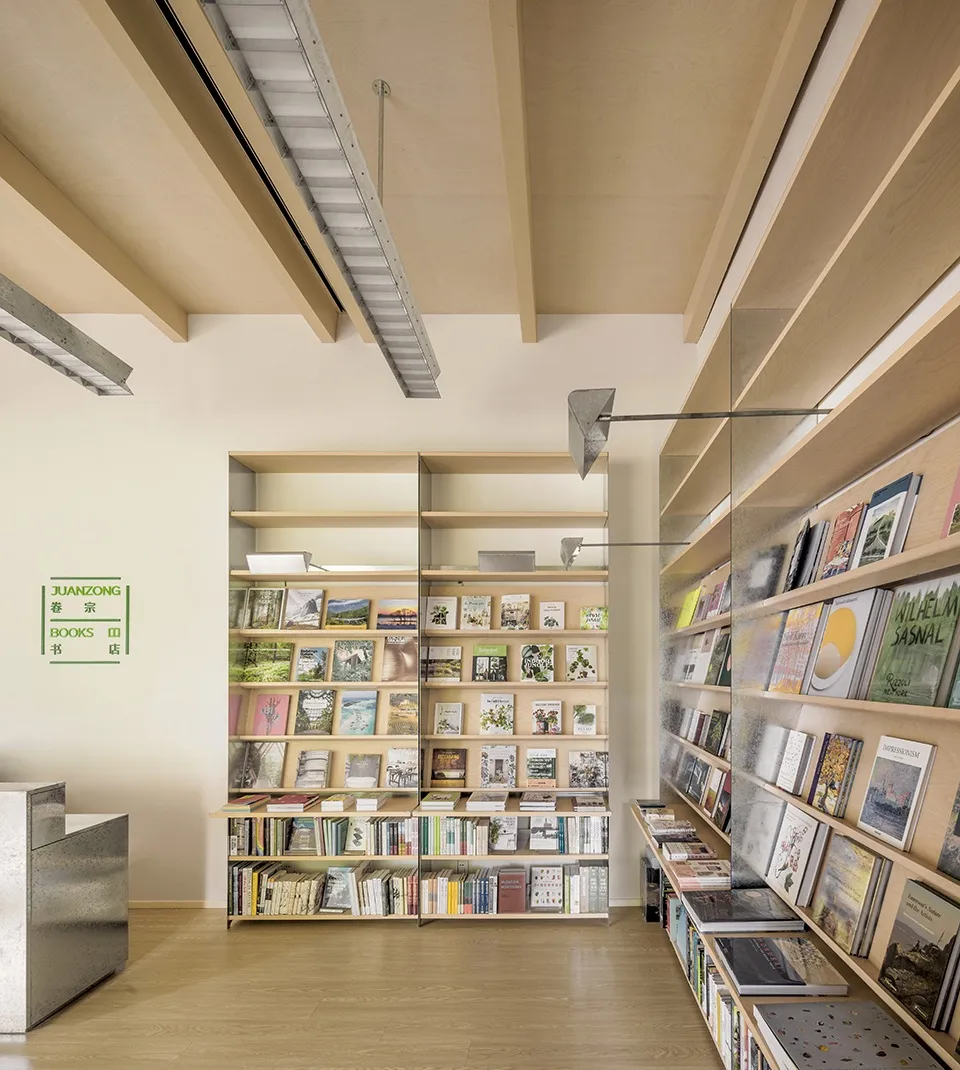 A modern library interior with wooden shelves and glass shelves displaying books.