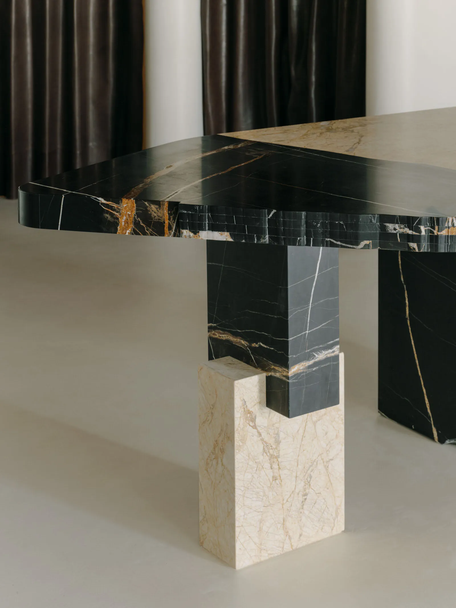 Modern, black marble dining table with geometric legs