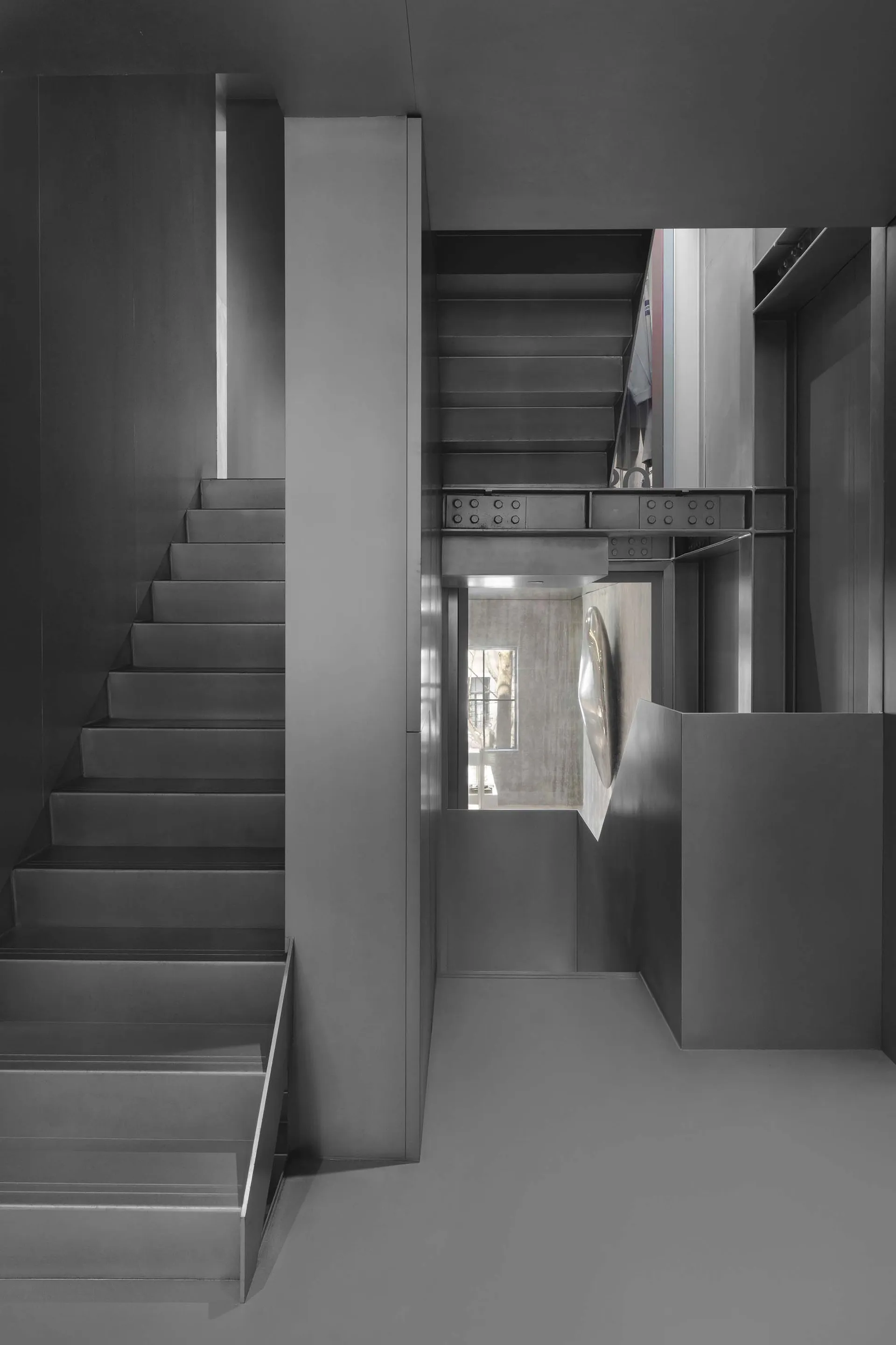 Modern minimalist staircase with metal railing and concrete steps.