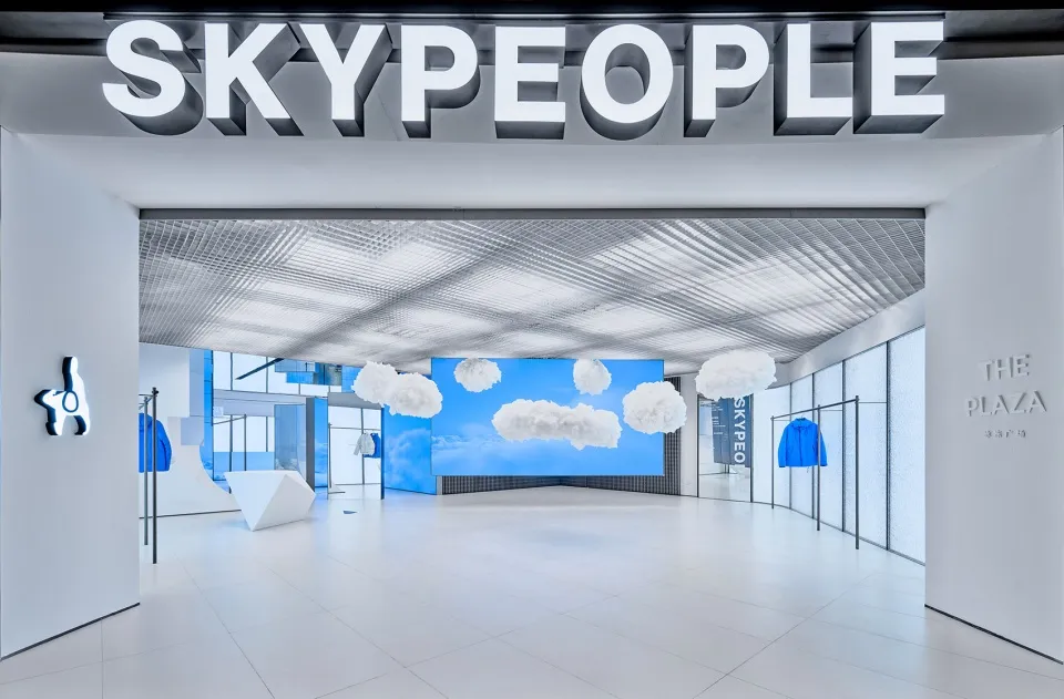 Modern storefront with glass walls and blue sky