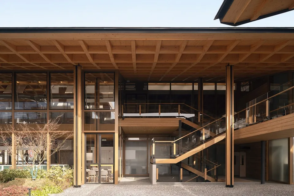A modern office space featuring wooden beams and a staircase.