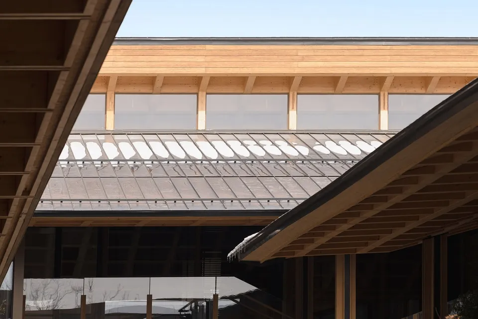 Modern building with wooden roof featuring marble tiles.