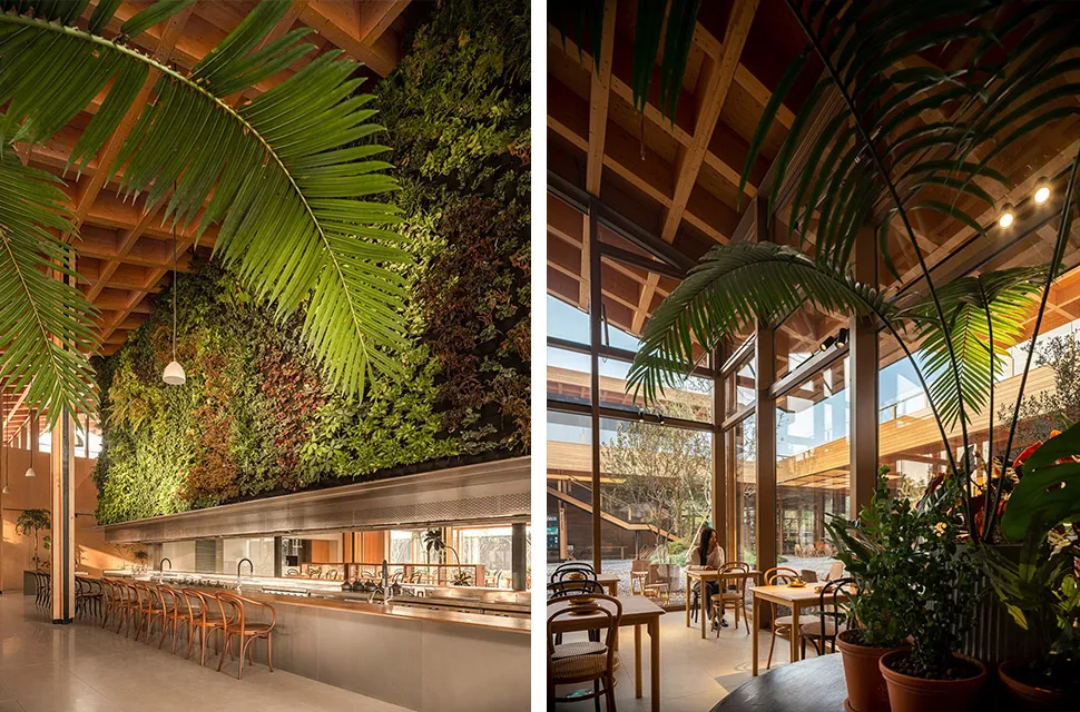 A modern cafe interior featuring wooden elements and a living wall.