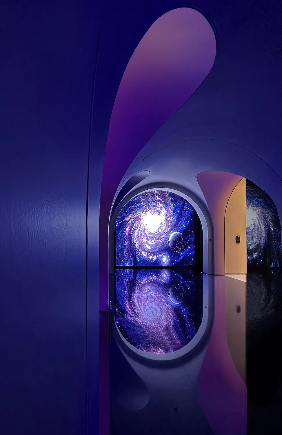 A modern architectural interior with a glass archway and a view of a galaxy.