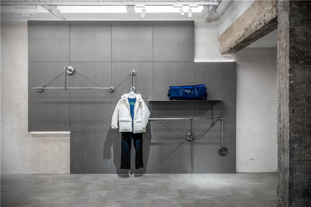 Modern retail store interior with concrete walls and metal structural elements