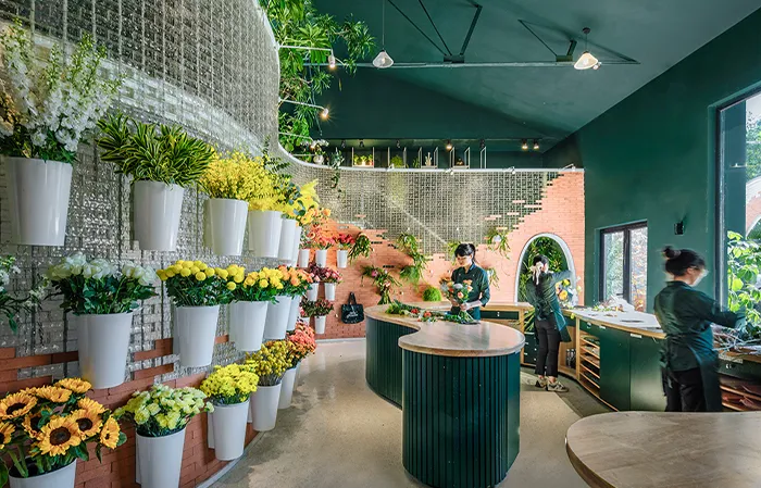 A modern flower shop with green plants and colorful flowers