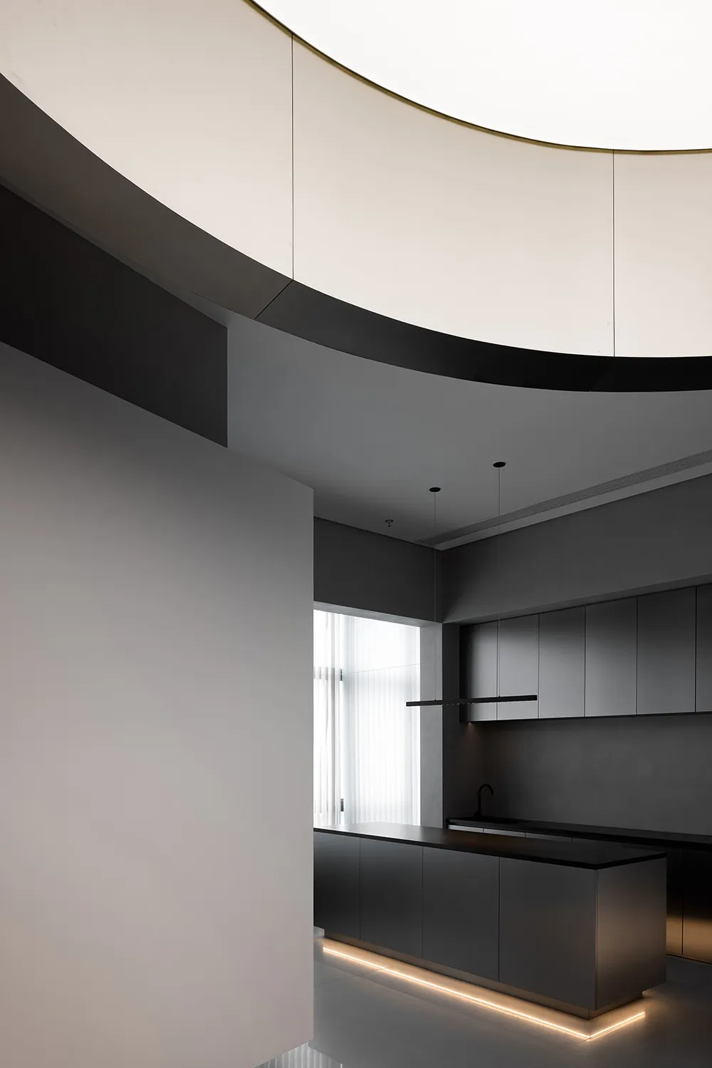 A modern minimalist kitchen featuring grey metallic cabinets and sleek design elements.
