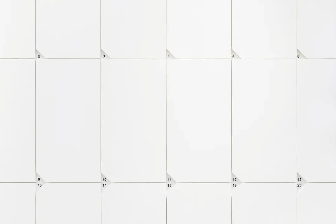 A modern calendar with a white paper design and a grid layout.