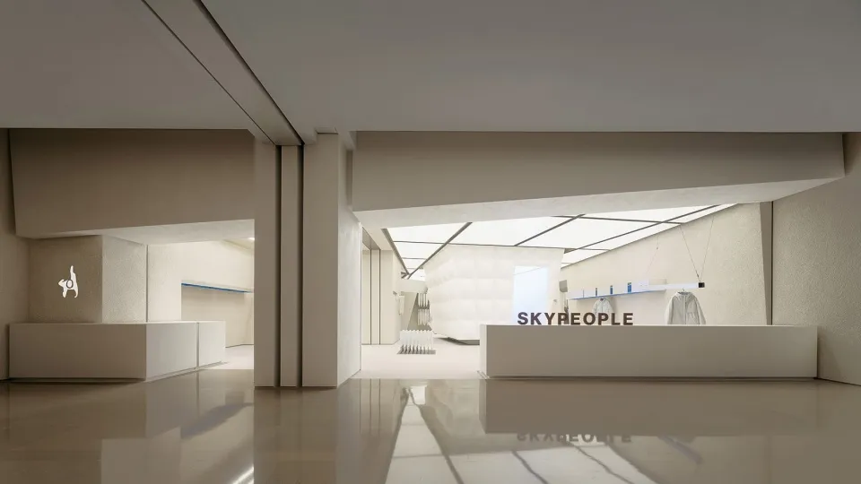 Interior view of a minimalist retail shop with white walls and floors.