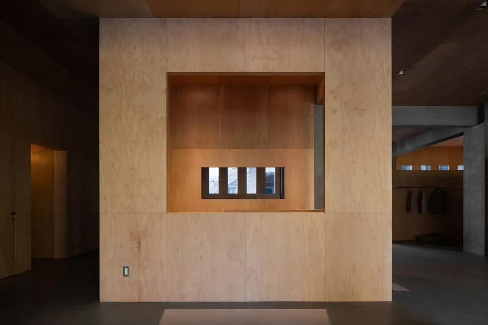 An image of a minimalist interior with wooden walls and a central cutout.