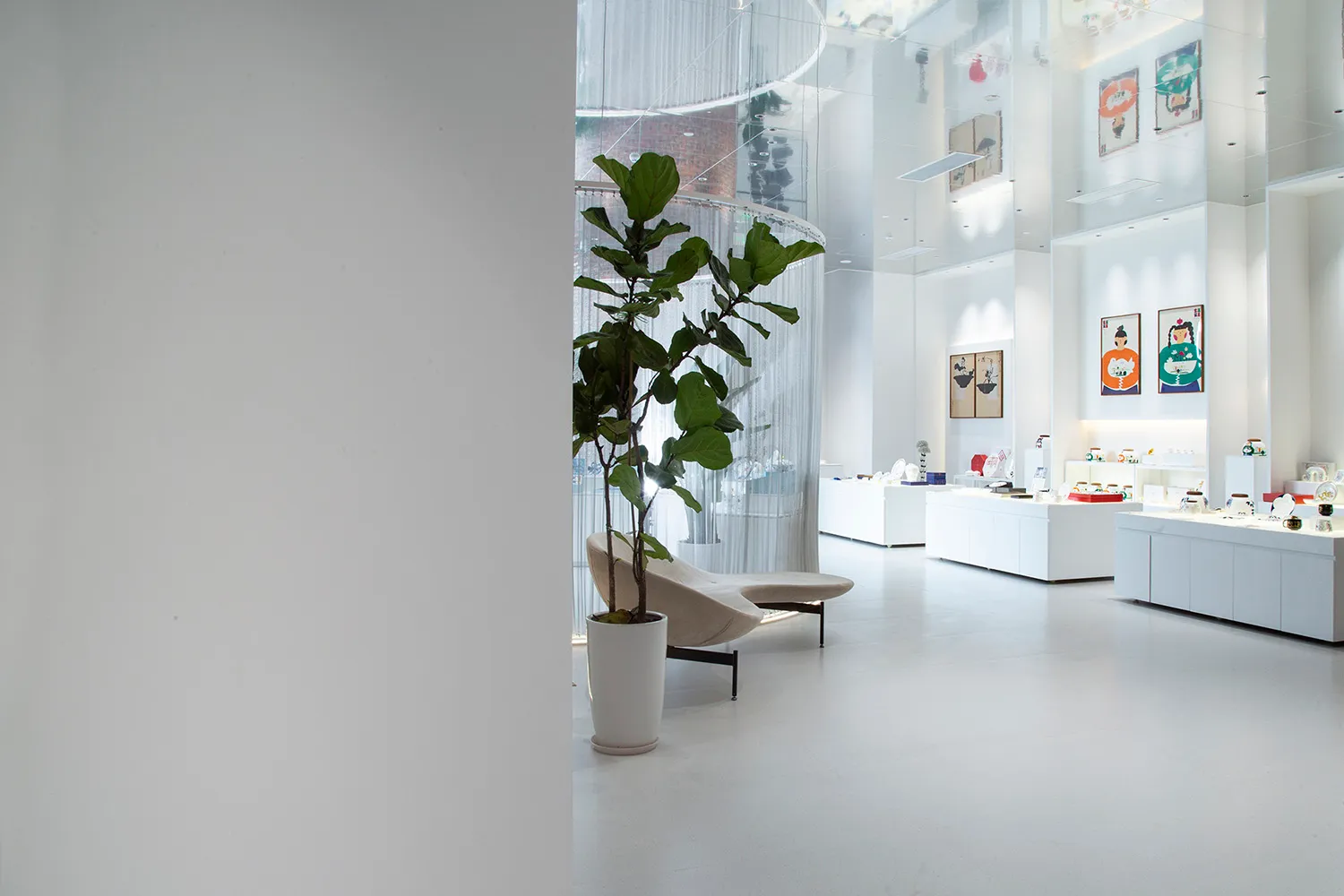 A minimalist retail storefront with white concrete materials and a clean, open space.