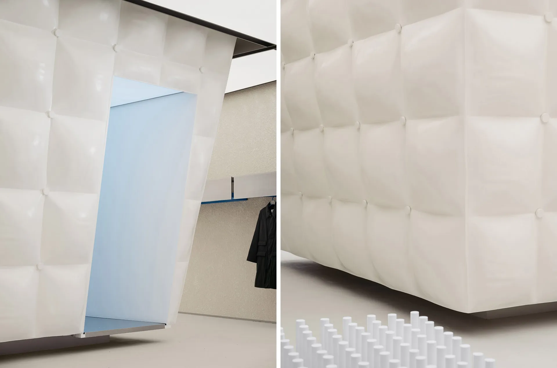Black and white minimalist interior with white textiles and a blue interior space.