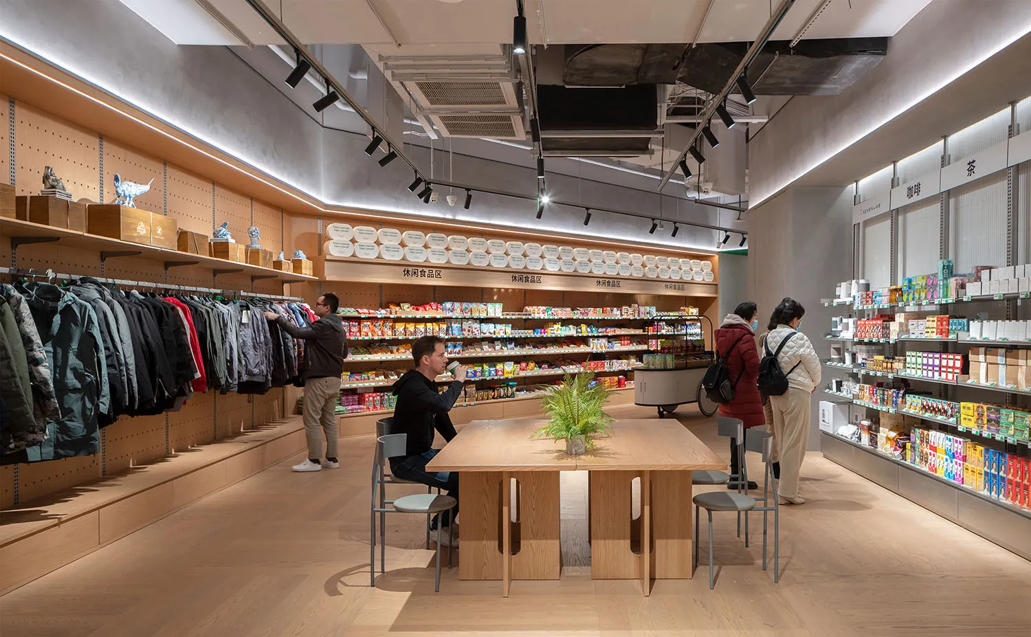 A modern cafe shop interior with shelves, tables, and chairs.