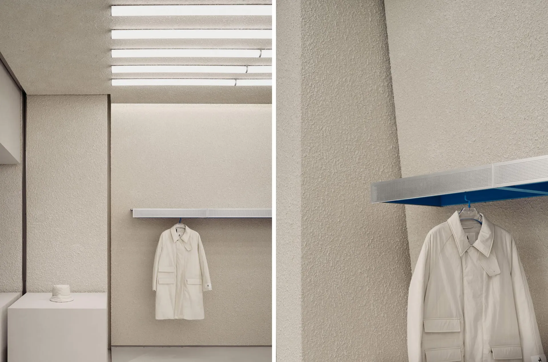 A modern clothing shop with a concrete-textured wall and minimalist design.