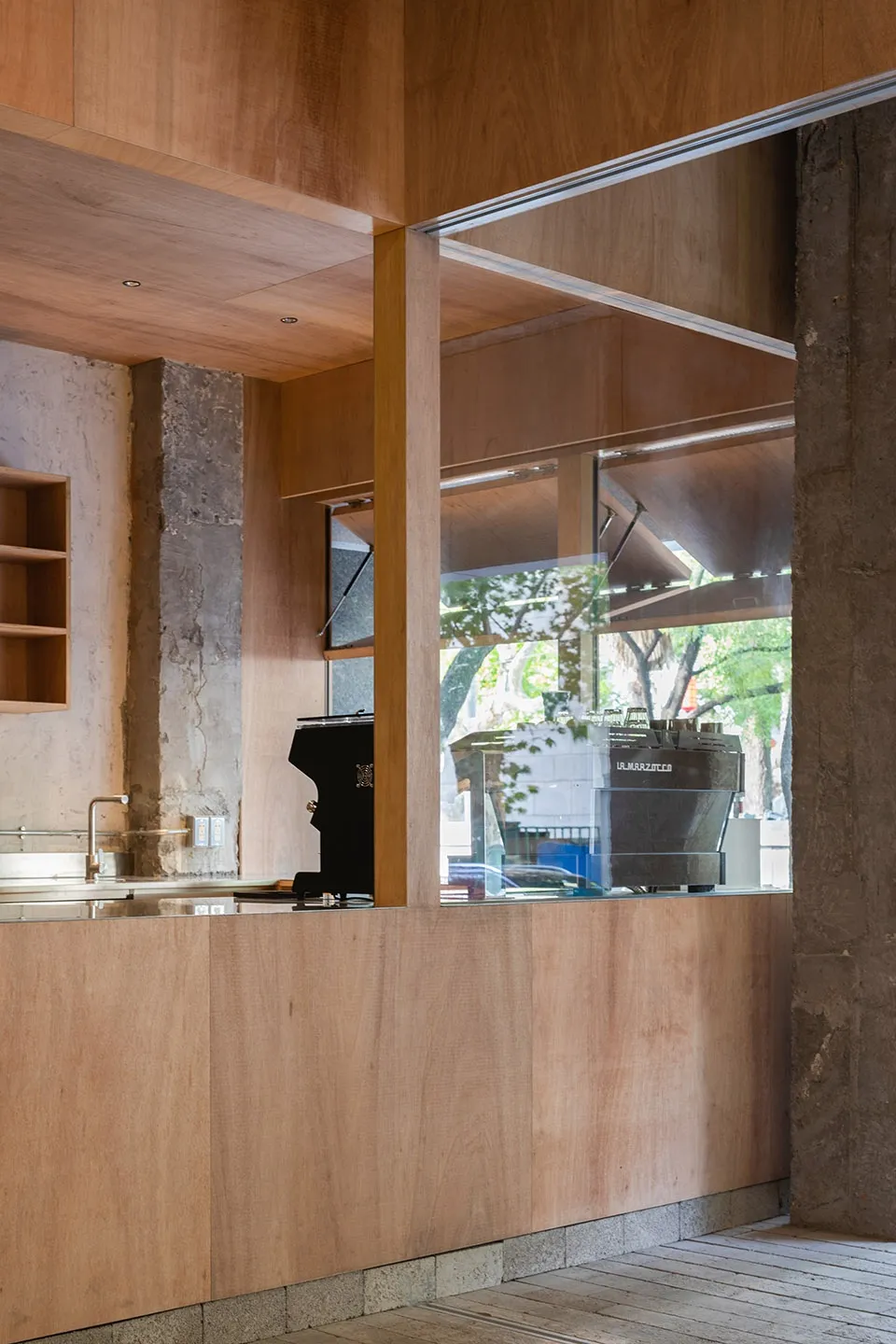 Wooden and concrete coffee shop counter with industrial design elements
