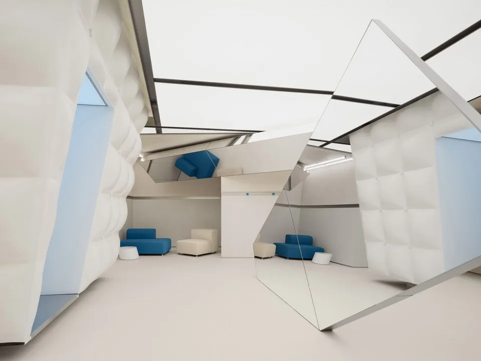 Modern interior library with white textured paneling and comfortable seating.