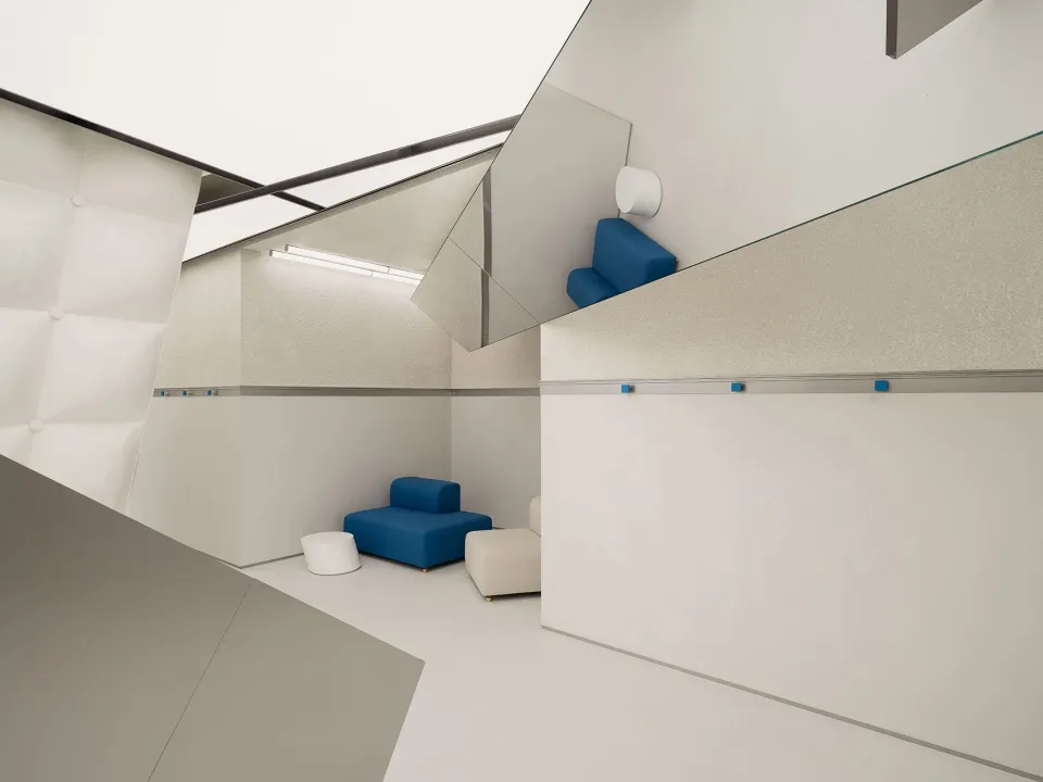 Modern, minimalist living space with concrete walls and floor.